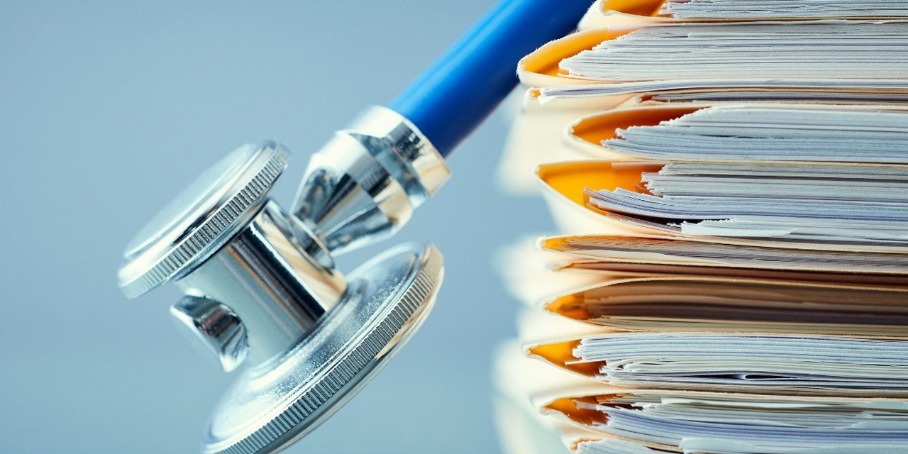 Stacked patient files and stethoscope used as evidence in California personal injury claims A stethoscope leaning on a large stack of patient folders, emphasizing the role of thorough medical records in supporting personal injury claims in California.