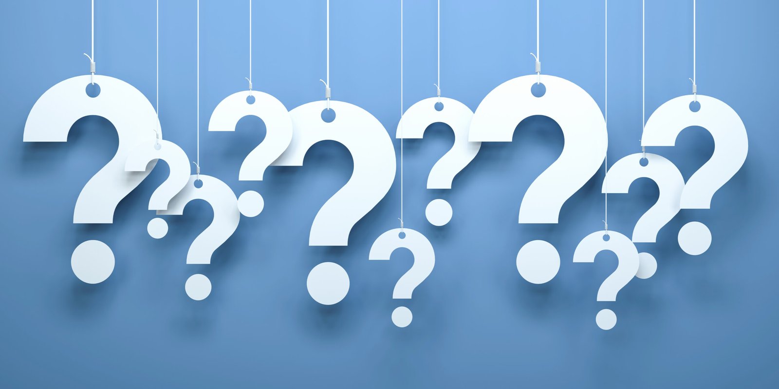 A series of large question marks hanging in the air, symbolizing questions to ask during an initial personal injury consultation.