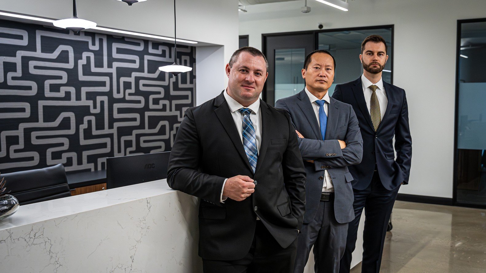 The legal team at Doyle Accident & Injury Attorneys stands confidently at their office reception, representing the commitment and professionalism clients expect from a top doyle accident law firm.