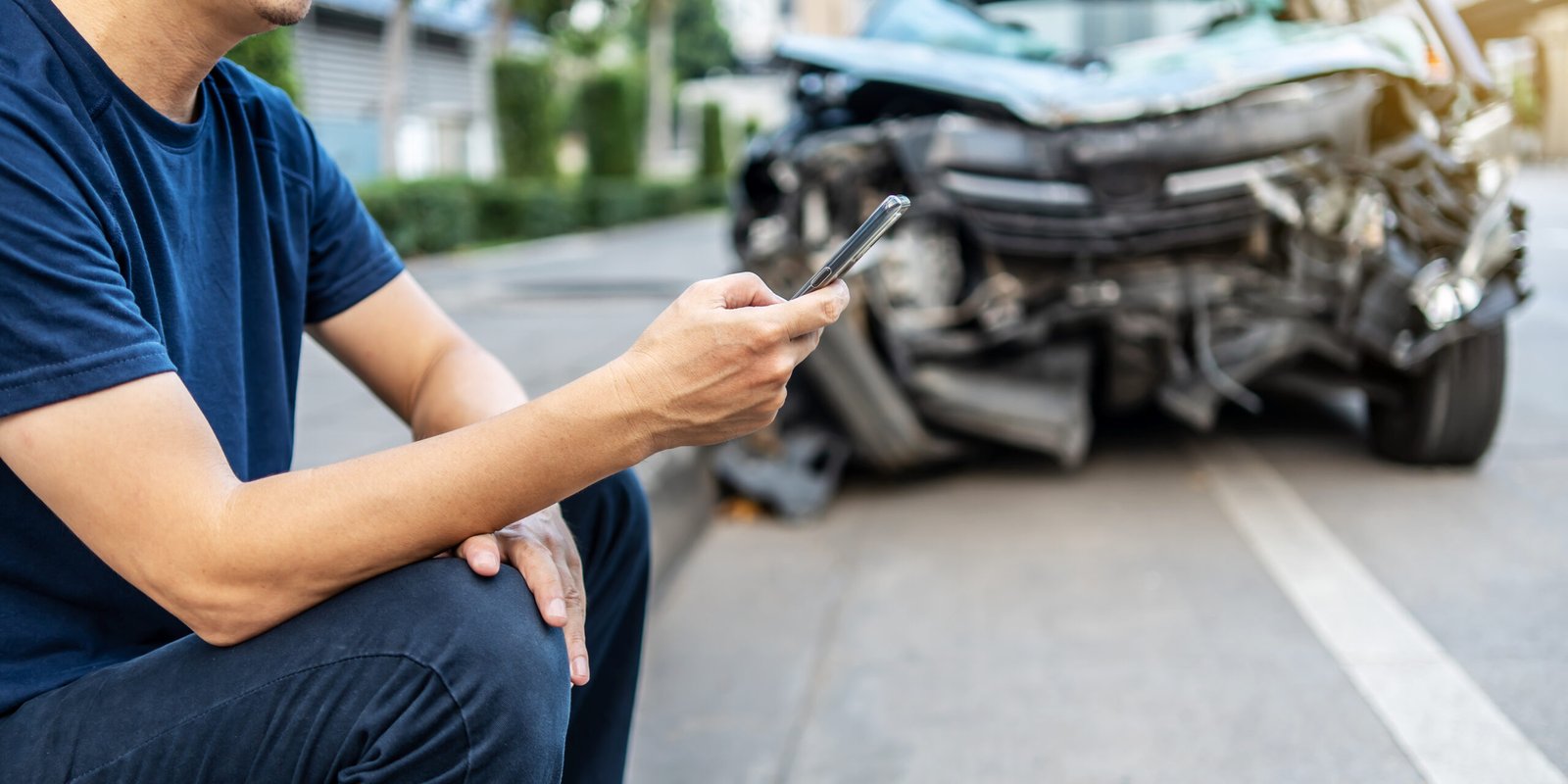 A man rides as a passenger in a car, looking at his phone while the female driver focuses on the road. This photo illustrates the everyday reality of rideshare trips in Alhambra and the importance of knowing your rights after a rideshare accident, especially with help from a personal injury attorney.